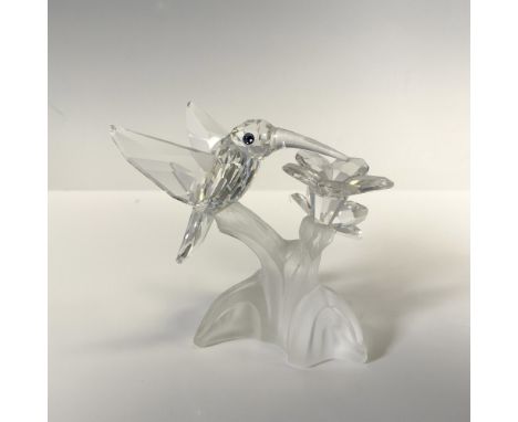 Crystal figurine lighting on flower on satin crystal base with wings spread observing with blue crystal eyes. Swarovski backs