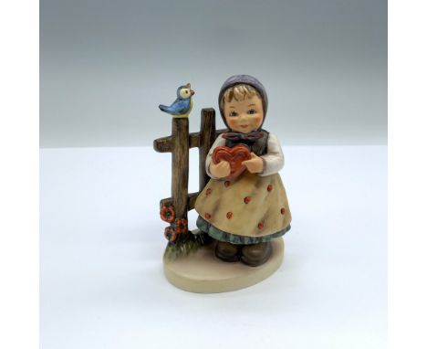 Hand-painted figurine depicting a young girl holding a heart next to a fence with a singing bird perched on top. Goebel backs