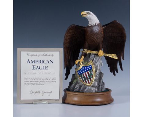 Hand painted fine porcelain figure of a majestic eagle perched on a rock, clutching arrows and standing over an American shie