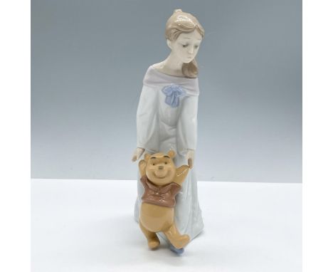 A beautiful figure from Nao by Lladro Disney collection, presenting a girl with the iconic character Winnie The Pooh. Nao Dis