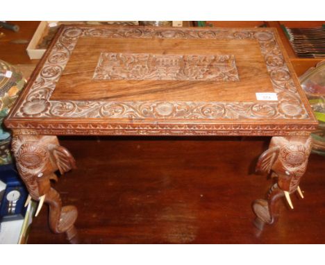 Carved hardwood Indian coffee table with elephants head and trunk legs