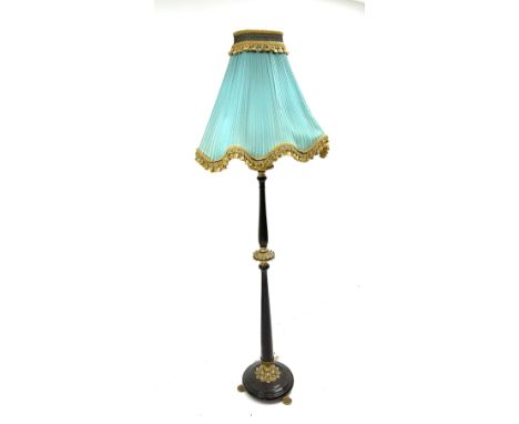 Late 20th century stained beech standard lamp with leaf cast gilt metal mounts, on cast paw feet, with a shaped shade upholst
