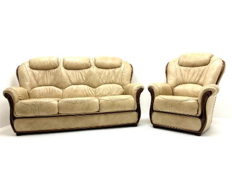 Three seat sofa upholstered in a cream leather (W178cm) and matching armchair (W85cm)