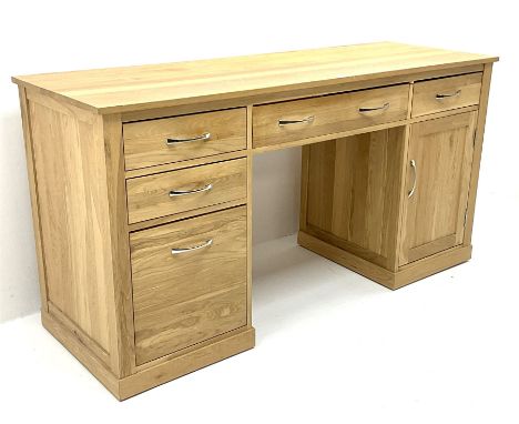 Light oak twin pedestal computer desk, one central long drawer flanked by two short drawers, above graduating drawers and cup