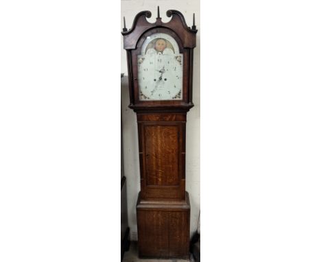 A 19th century oak and mahogany longcase clock, the hood with a broken swan neck pediment and fluted columns above a long tru