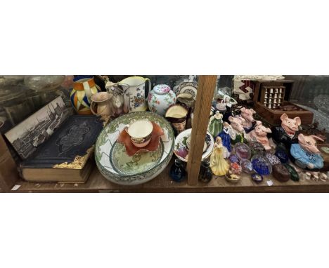 A large lot including a Clarice Cliff Harvestware jug, Royal Doulton figures, Royal Doulton, Wade Natwest piggies,  bible, ca