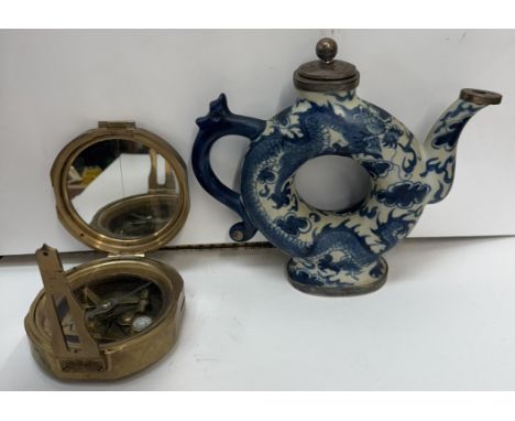 A Chinese blue and white teapot of circular form with white metal mounts together with a brass compass