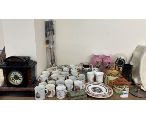 A black slate mantle clock together with commemorative china, pink glass vases, Hettich anniversary clock, cottageware teapot