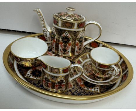 A Royal Crown Derby 1128 miniature tea set, comprising a tray, teapot, cream jug, sugar basin, cup and saucer 