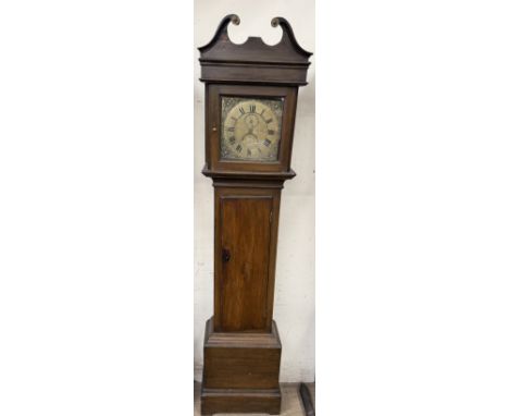 A 19th century pine longcase clock with a broken swan neck pediment above a long trunk door on a box base and bracket feet, t