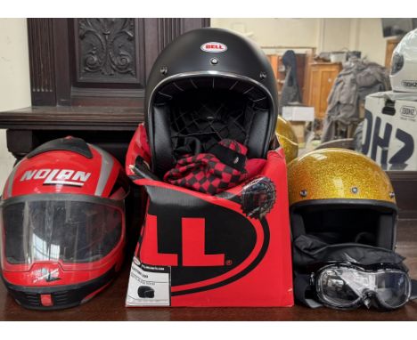 A Bell Custom 500 matte black solid size large motorcycle helmet with box and cover together with a Daytona motorcycle helmet