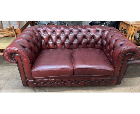 A Thomas Lloyd two seater button back upholstered chesterfield settee