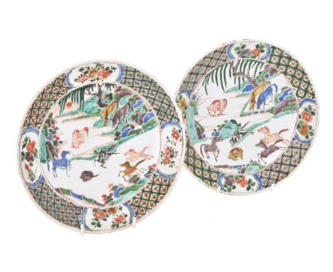 A pair of Chinese famille verte 'eight horses' plates, Kangxi, with underglaze blue jue marks to bases within double circle, 