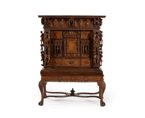 A carved walnut cabinet, incorporating 17th century elements, above a  later stand, 128cm high, 93cm wide, 49cm deep Conditio