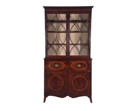 A George III mahogany cabinet bookcase, circa 1800, the glazed helix-moulded doors enclosing adjustable shelves, above a frie