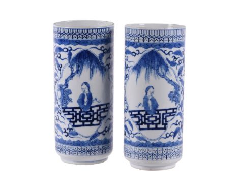 A pair of Chinese blue and white cylindrical vases, Qing Dynasty, late 19th century, each painted with a lady in a garden to 