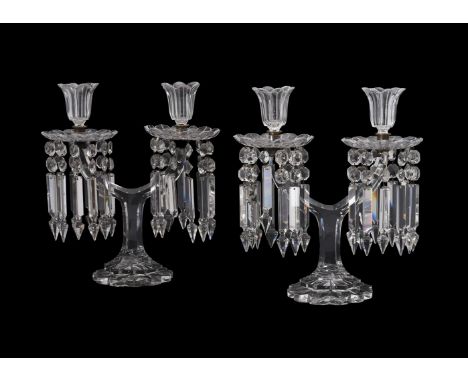 A pair of glass twin light table lustres, 20th century, each with a floriform sconce above the drip pans and lustre drops, an