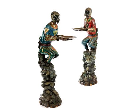 A PAIR OF ITALIAN CARVED AND PAINTED MONKEY WAITERS VENETIAN, MID-19TH CENTURY each modelled perched on a pile of rocks, with