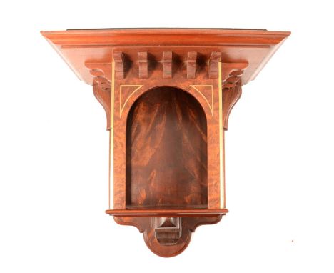 Regency style mahogany and brass inlaid wall bracket, the moulded shelf raised above an arched recess, shaped backplate, widt