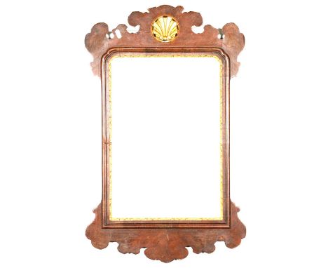 Chippendale style wall mirror, fretted mahogany frame with gilt shell pediment, rectangular glass, 76x48cm.
