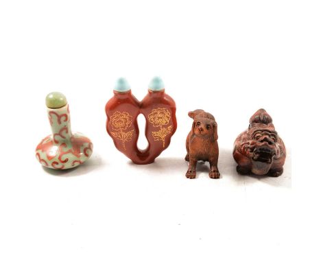 Two wooden netsuke, one carved with dogs, signed, 5cm, the other as a beast, and two porcelain scent bottles.Qty: 4Condition 