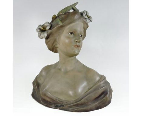 An early 20th century French Art Nouveau painted plaster Le Lis portrait bust, by Faggioni, of a young lady, with flowers in 