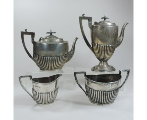 An Edwardian four piece silver tea and coffee service, of half gadrooned oval shape, by Walker and Hall, Sheffield 1905 (4)