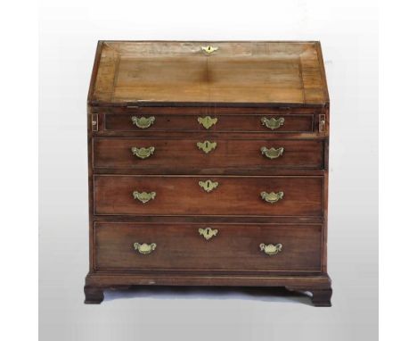 A George III mahogany and crossbanded bureau, having a fitted interior with a sunken well, on ogee bracket feet, 88cm