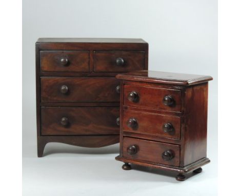 An early 19th century mahogany apprentice chest, with ebony stringing, containing two short over two long drawers, on swept b