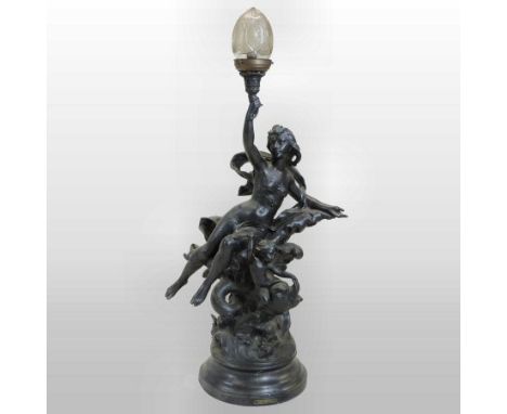 An early 20th century spelter figural table lamp, after J. Jermain, in the form of a young lady and a cherub riding on a fish