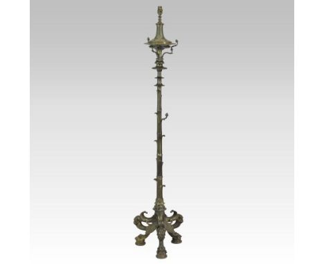 An ornate 19th century gilded cast iron standard lamp, on a shell cast base, terminating in paw feet, 155cm tall