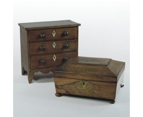 A Regency rosewood and cut brass inlaid work box, of sarcophagus form, on turned feet, 27cm, containing a collection of cigar