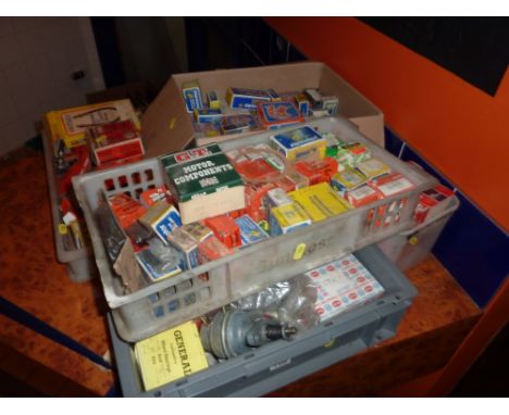 FIVE BOXES OF VINTAGE CAR PARTS, including rotor arms, distributor caps etc