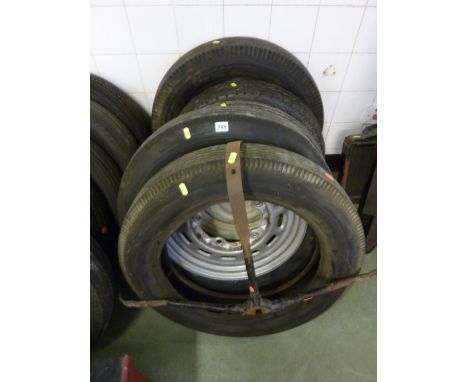 THREE VINTAGE WHEEL AND TYRES, two tyres and a vintage spare wheel carriage (6)