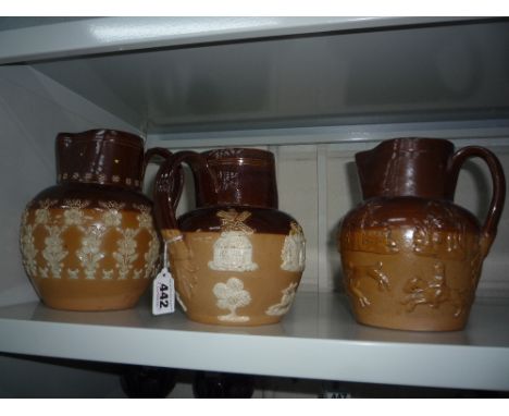 THREE ROYAL DOULTON STONEWARE JUGS, raised hunting scenes, flowers etc, height approximately 20cm tallest (hairlines) (3)