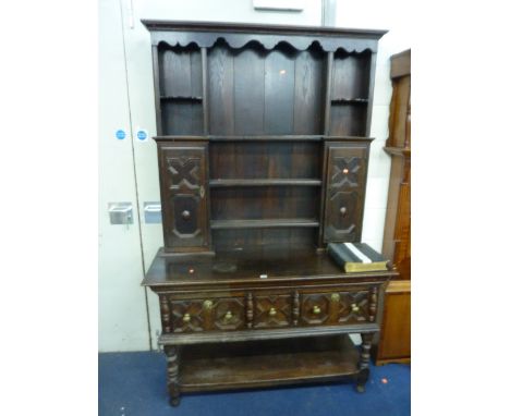 AN OAK DRESSER, the plate rack with cupboards above a three drawer base with lower shelf