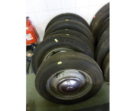 FIVE VINTAGE WHEELS AND TYRES, with Morris hub caps