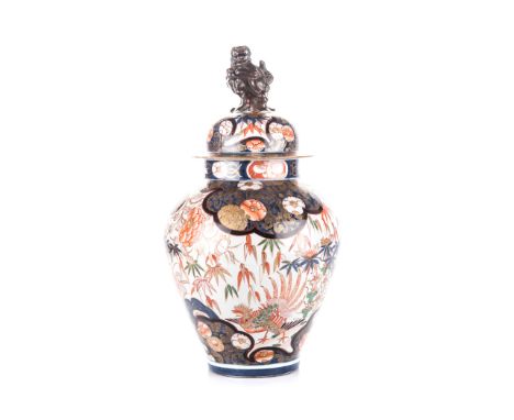 A JAPANESE IMARI VASE WITH COVER, MEIJI, 1868 – 1912 of tapering ovoid form, the body depicting a phoenix and peacock amongst