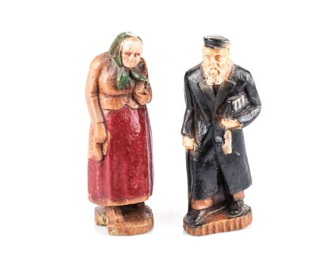A PAIR OF CARVED AND PAINTED WOODEN FIGURES OF A RABBI AND HIS WIFE, POLAND, CIRCA 1850 made out of Syroco wood and resin, 14