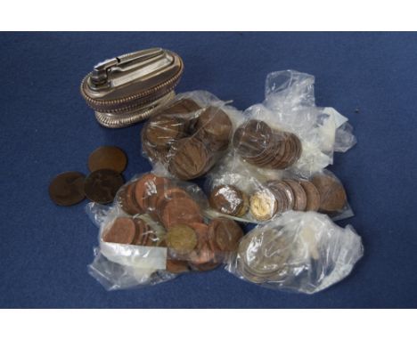 A collection of modern British coins, including shillings, six pences, with some pennies, together with a Ronson table lighte