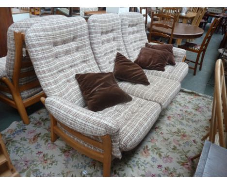 An Ercol light elm three seater sofa with checkered oatmeal fabric