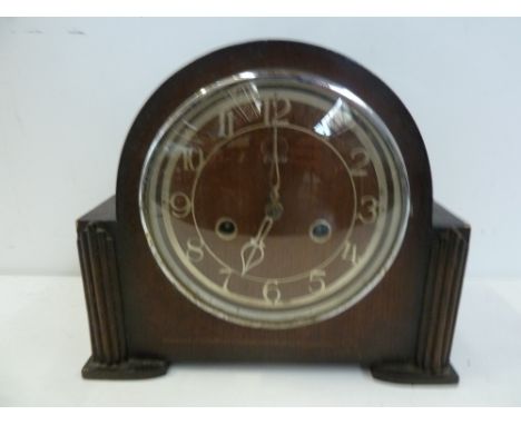 An Enfield oak cased mantle clock, wooden dial with Arabic numerals