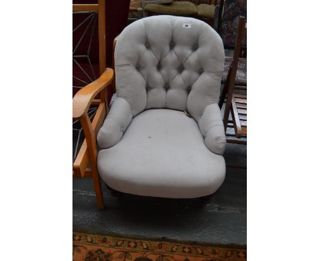 A Victorian button back nursing chair with turned legs and castors, recently reupholstered