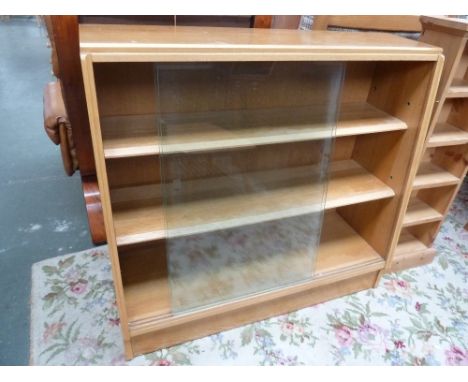 A 20th century light oak bookcase, two shelves and glass sliding doors 91cmW