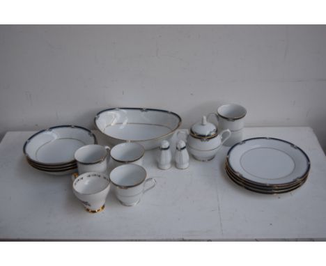 A Noritake 'Impression' part dinner service including side plates, dinner plates, jugs, teapot, mugs and servers
