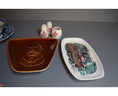 A Poole Pottery cruet set in traditional pattern together with two Hardy based dishes