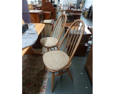 A set of four light elm Ercol spindle back dining chairs