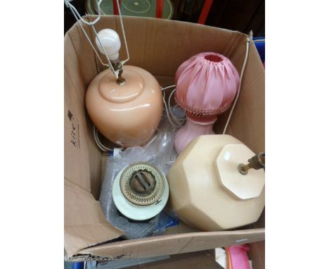 An oil lamp, a pink side lamp with pink shade, an octagonal beige lamp base, with an orange lamp base, with some shades