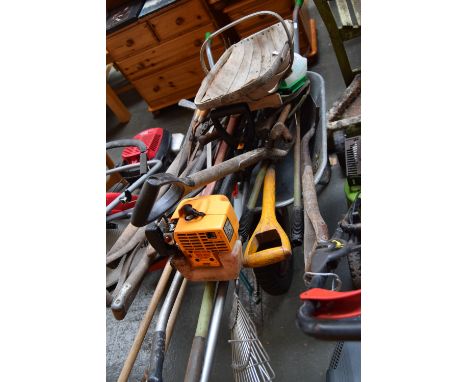 A wheel barrow and a large quantity of gardening tools to include a McCulloch TM 250 petrol strimmer