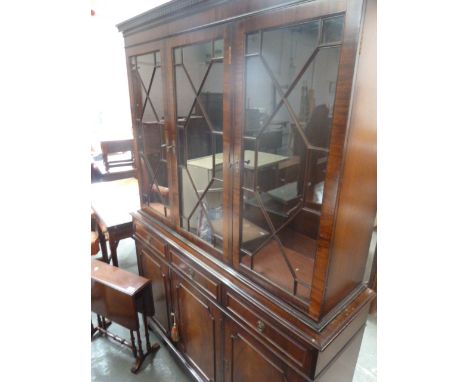 A 20th century mahogany dresser, glazed doors over three drawers and three panelled cupboards, on bracket feet